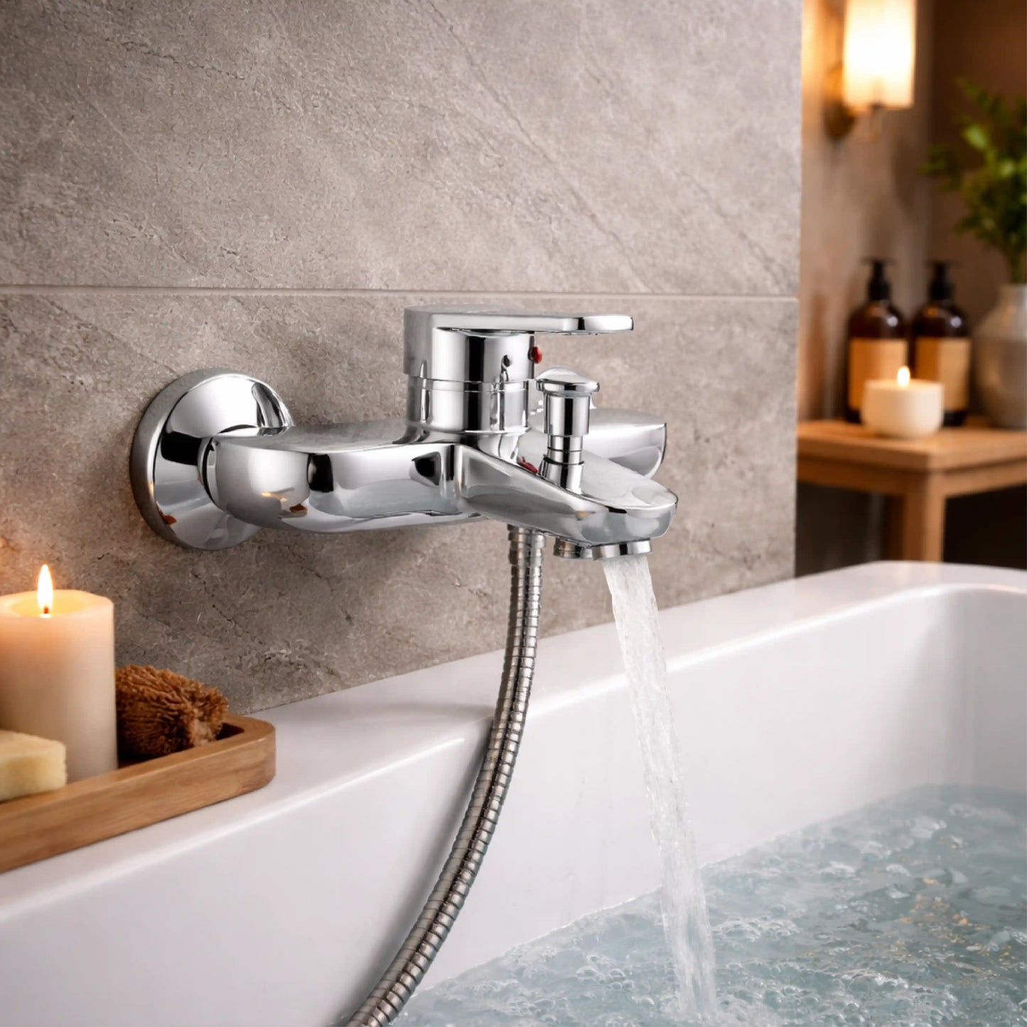 Sanitar CORAL-BM wall-mounted brass bath mixer with a polished chrome finish, featuring single-handle controls and a central diverter spout.
