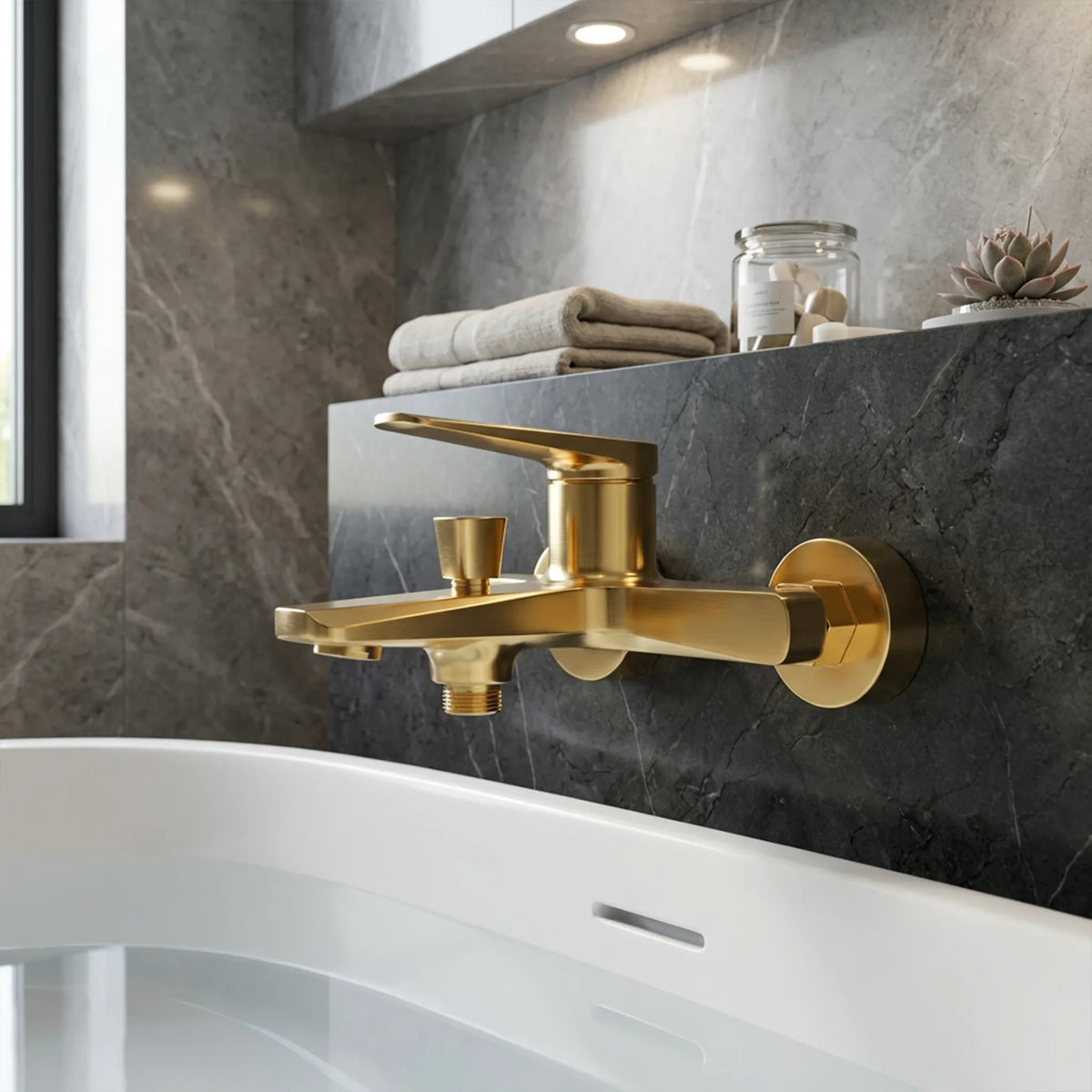 Sanitar ATRI-BM GD wall-mounted bath and shower mixer in polished gold, featuring a single-lever handle, tapered square diverter, and a geometric flat spout.