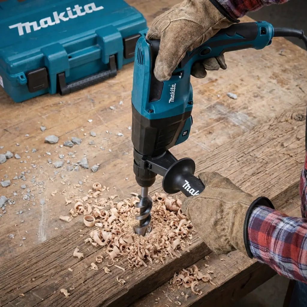 Worker in leather gloves using a Makita hammer drill with an auger bit to bore through a wooden beam.