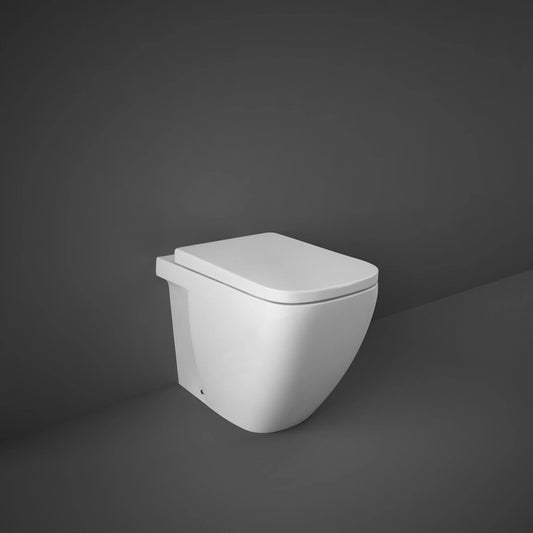 A studio photograph of the RAK-Caroline 55cm Back To Wall water closet pan in Alpine White, showcasing its distinctive rounded-rectangle shape and seamless floor-standing profile.