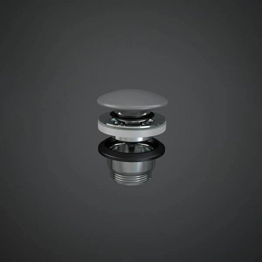 RAK Ceramics Duo click-clack basin waste with a circular ceramic pop-up plug in Matt Grey (DUO000503A) on a chrome-plated body.