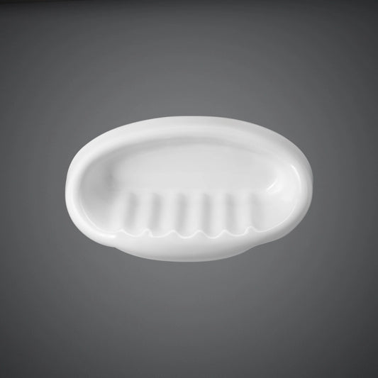 A front-facing studio shot of the RAK-Europa Small Soap Holder in Alpine White, highlighting its smooth ceramic finish and minimalist oval design.