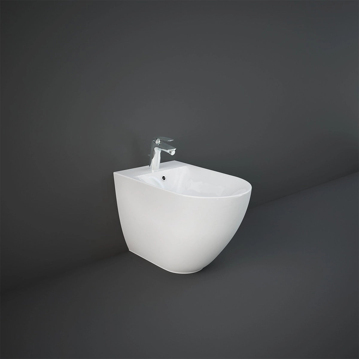 A studio shot of the RAK-Des 58cm Back To Wall bidet in Alpine White, showcasing its smooth oval shape, minimalist lines, and single tap hole.