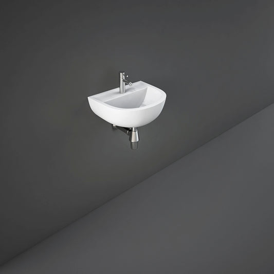 RAK Compact 38cm alpine white wall hung wash basin featuring an oval bowl shape and pre-drilled single tap hole.