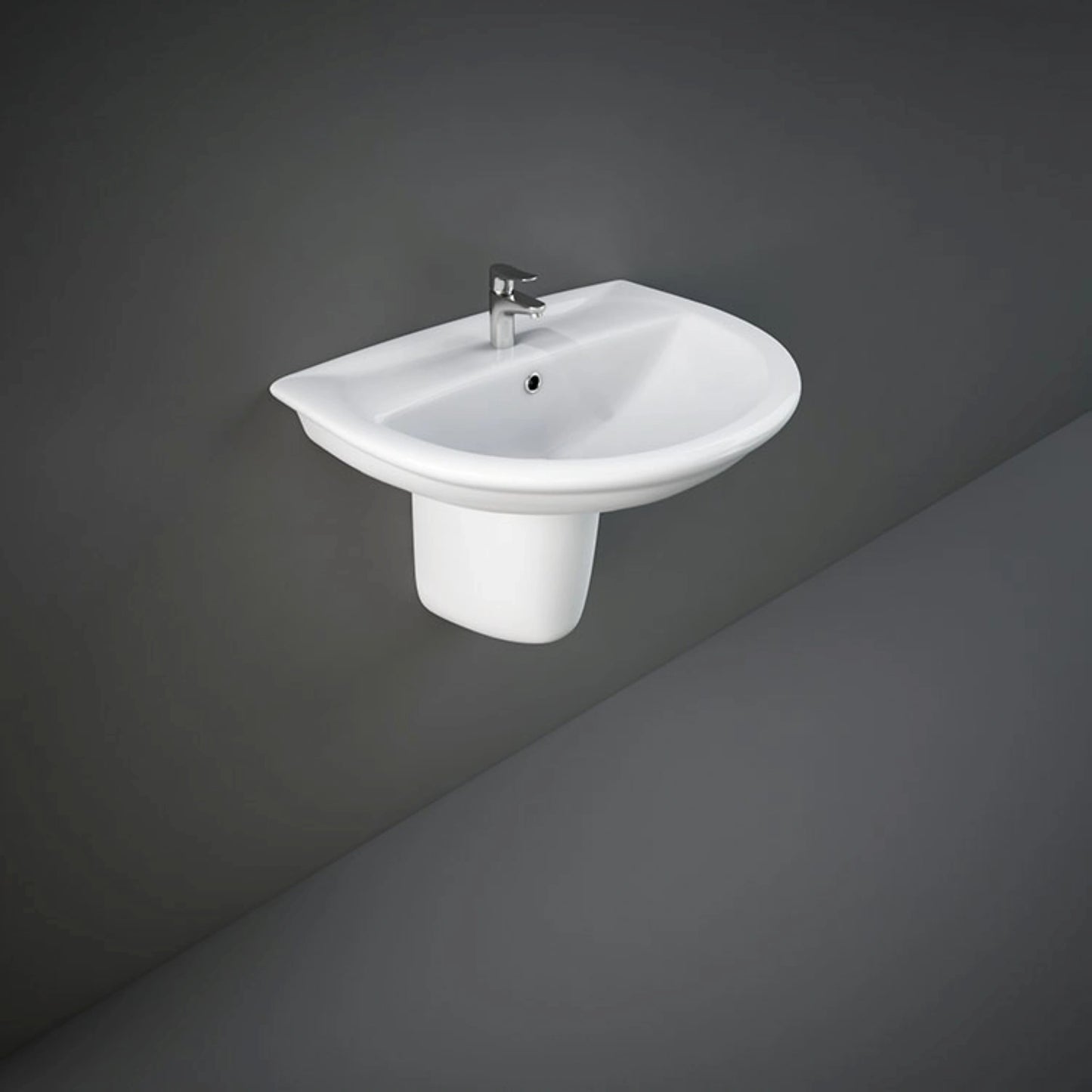 Front perspective view of the 65cm RAK Ceramics Karla oval ceramic wash basin in Alpine White, mounted with its matching sleek half pedestal.