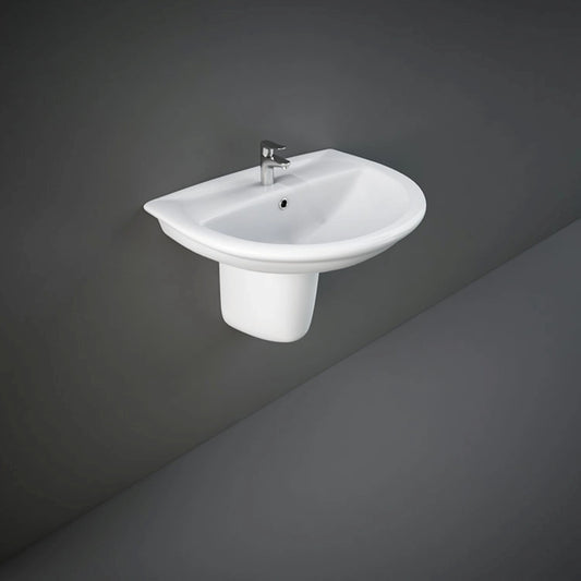 Front perspective view of the 65cm RAK Ceramics Karla oval ceramic wash basin in Alpine White, mounted with its matching sleek half pedestal.