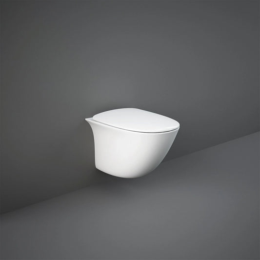 A grey space featuring a RAK Ceramics Sensation toilet equipped with the white normal-close seat cover, emphasizing a clean and hygienic atmosphere.