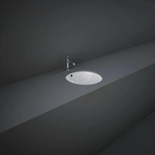 RAK-Variant 36cm round under-counter wash basin in glossy Alpine White, showing its rimless interior bowl construction and hidden undermount design.