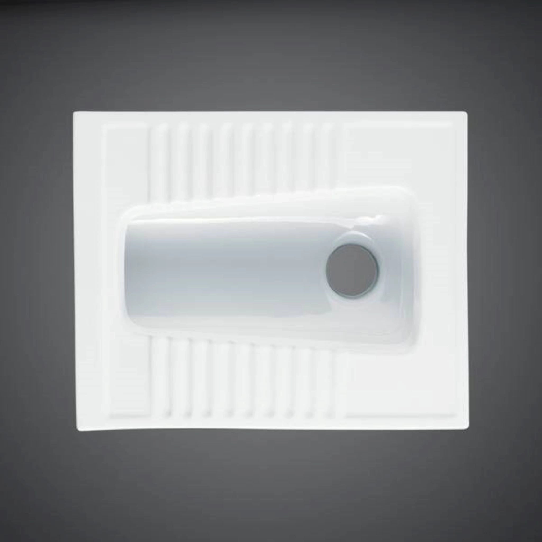 RAK Ceramics Alpine White Asian squatting pan (OC01AWHA) with a rectangular bowl design and integrated anti-slip foot treads.