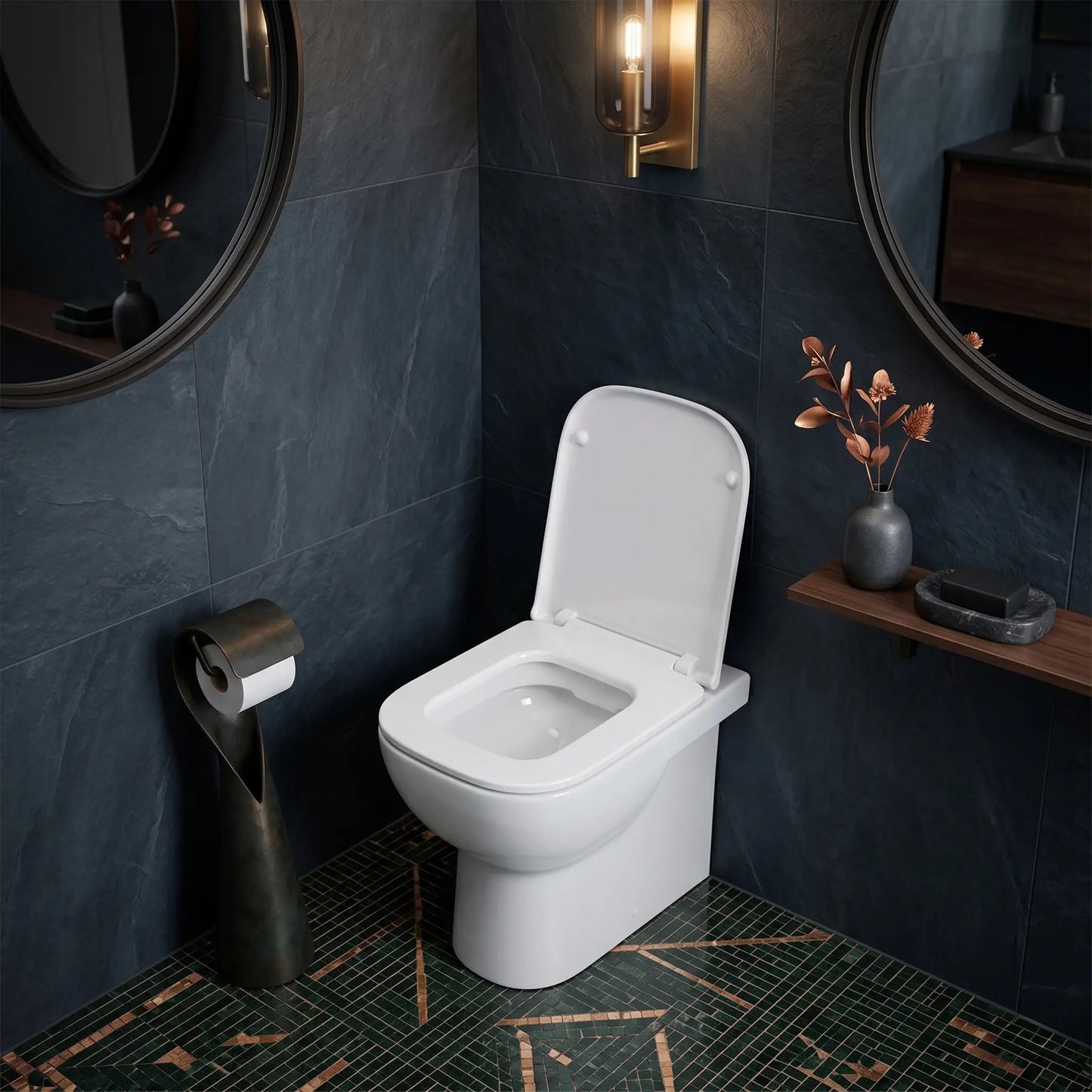 Modern luxury bathroom featuring a RAK Ceramics floor-mounted toilet with the Metropolitan slim soft-close seat installed, set against dark slate wall tiles and a decorative green mosaic floor.