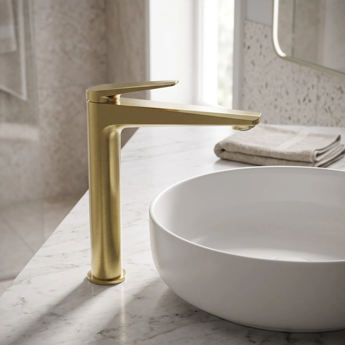 Sanitar Atri Series high brushed gold washbasin mixer tap paired with a white round vessel sink on a marble countertop.