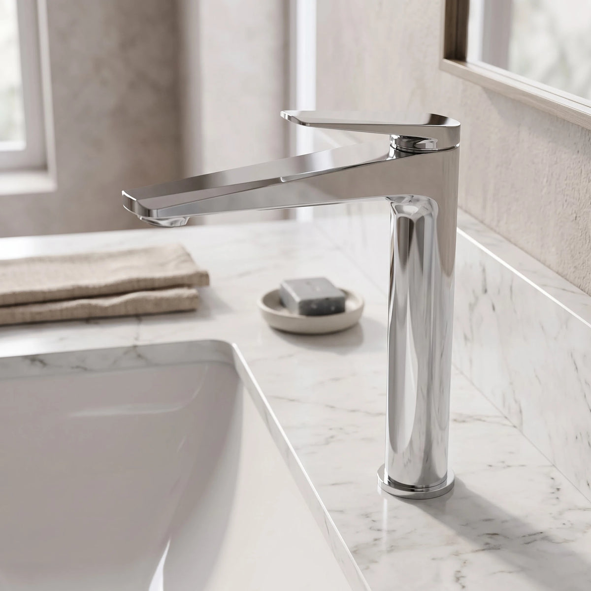 Sanitar Atri Series tall chrome high washbasin faucet mounted beside an undermount sink on a marble vanity top.