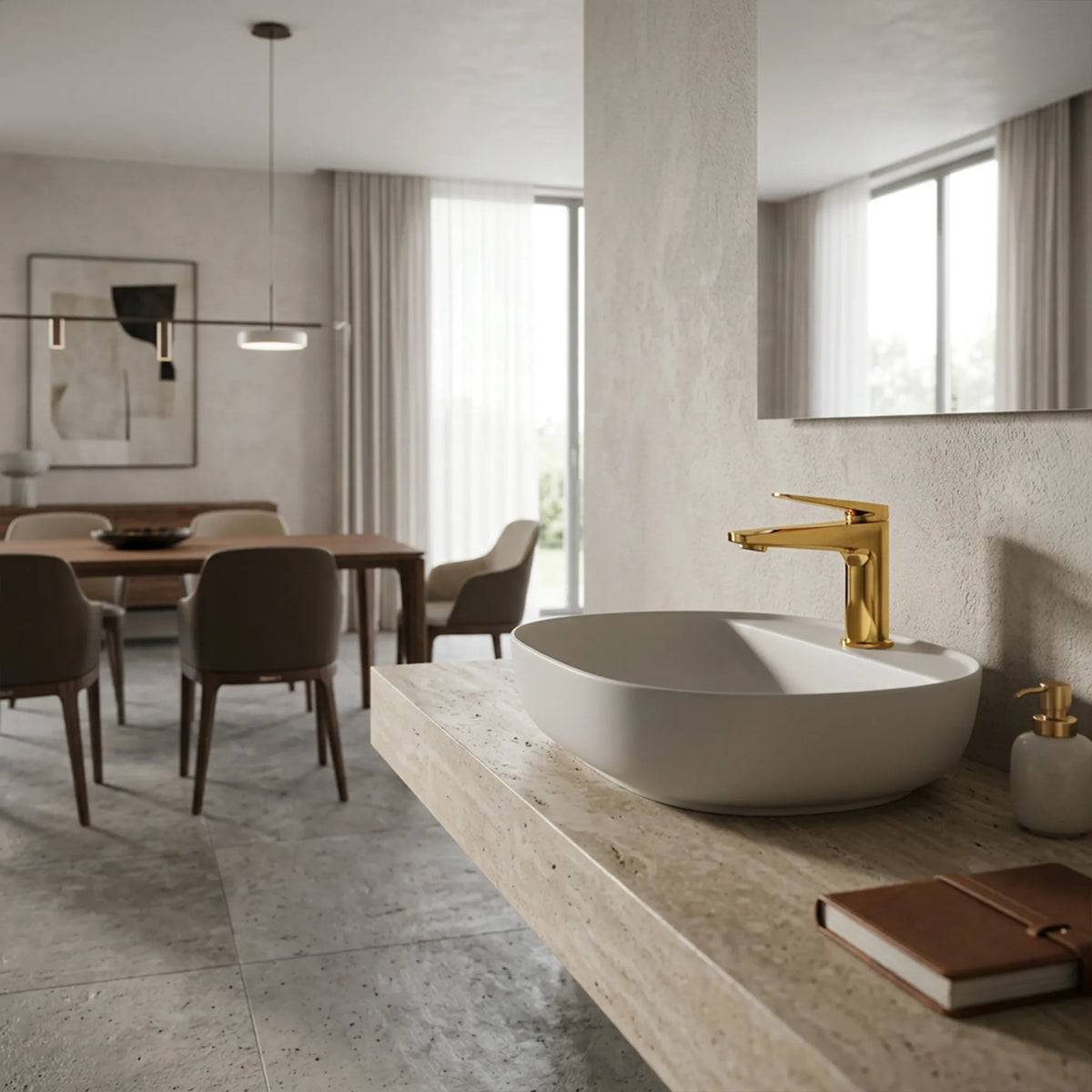 Sanitar Atri Series polished gold washbasin mixer installed on a white oval vessel sink over a stone vanity. 