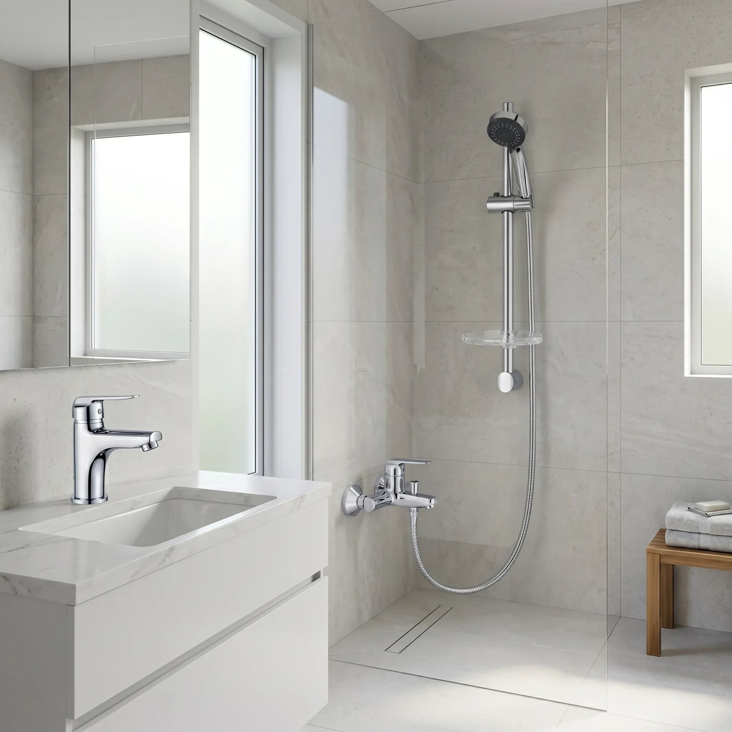 Modern white bathroom featuring the Strohm Teka Inca combo set, showing the basin mixer installed on a marble vanity and the shower rail system with a wall-mounted mixer in a bright, clean walk-in shower area.
