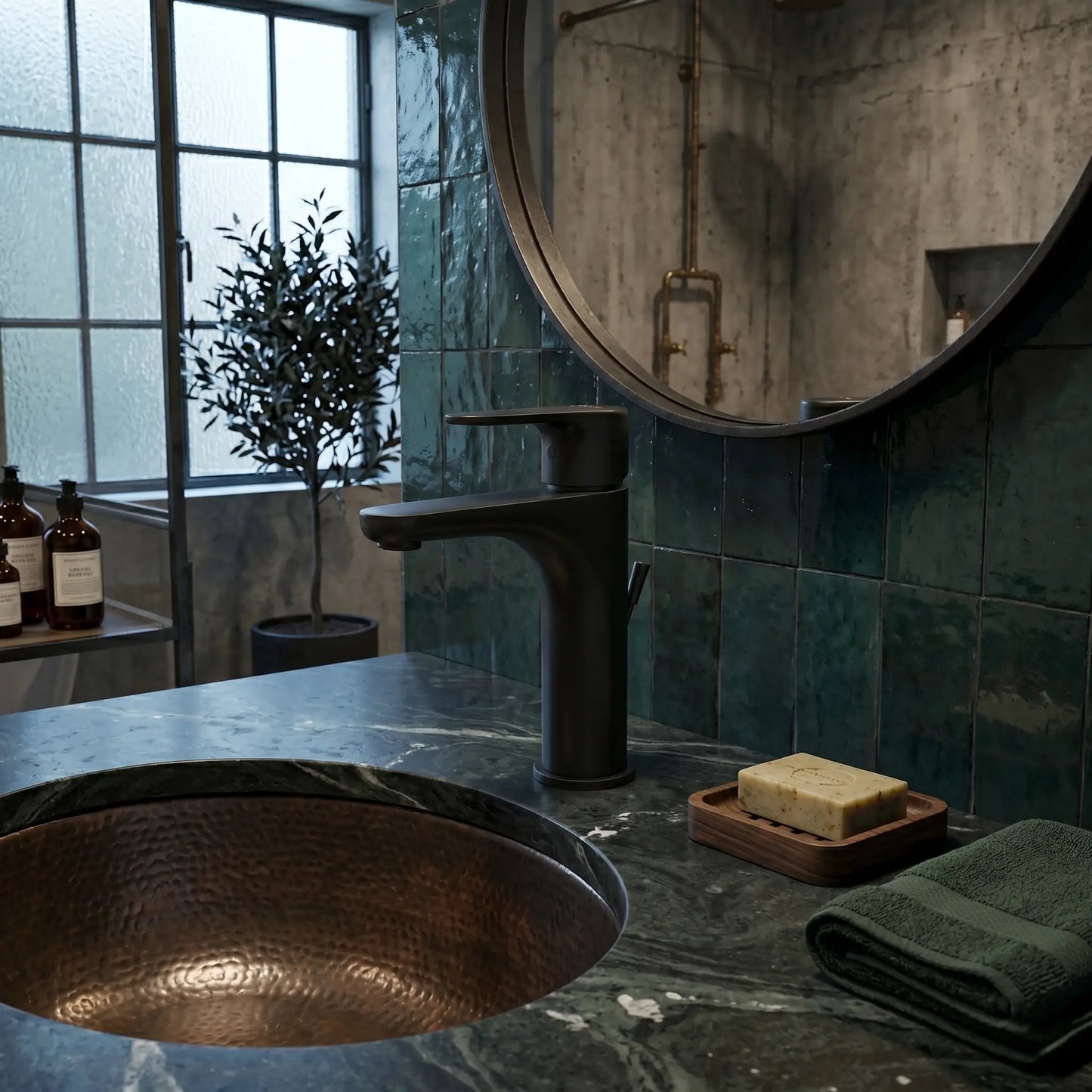A sophisticated industrial-style bathroom featuring the VitrA matte black basin mixer installed on a dark green marble countertop with a hammered copper vessel sink and emerald green wall tiles.
